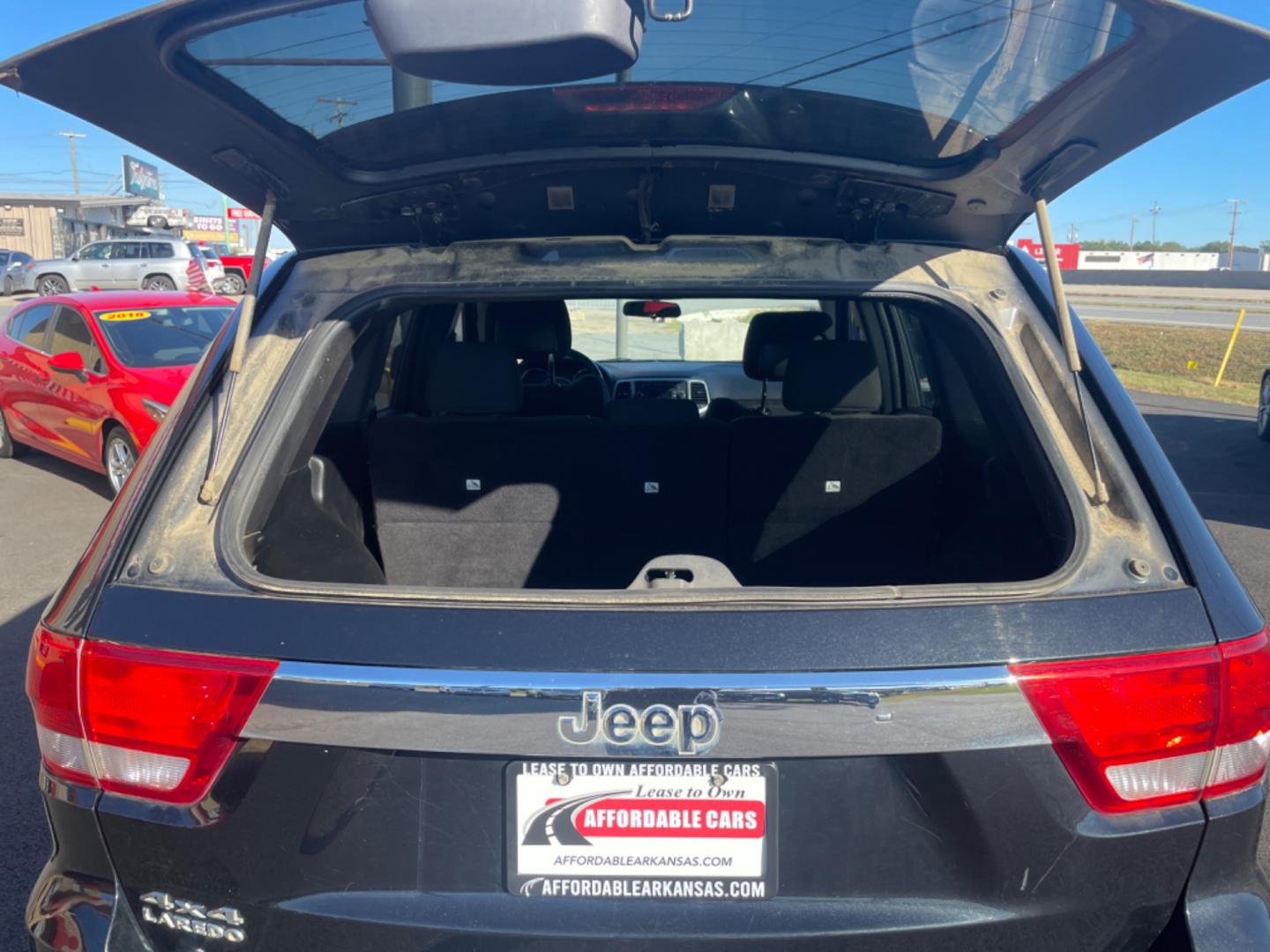 2012 Black Jeep Grand Cherokee (1C4RJFAG9CC) with an V6, Flex Fuel, 3.6 Liter engine, Automatic, 5-Spd transmission, located at 8008 Warden Rd, Sherwood, AR, 72120, (501) 801-6100, 34.830078, -92.186684 - Photo#11