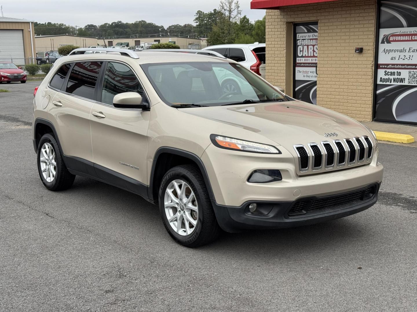 2014 Gold Jeep Cherokee (1C4PJLCB3EW) with an 4-Cyl, 2.4 Liter engine, Automatic, 9-Spd transmission, located at 8008 Warden Rd, Sherwood, AR, 72120, (501) 801-6100, 34.830078, -92.186684 - Photo#1