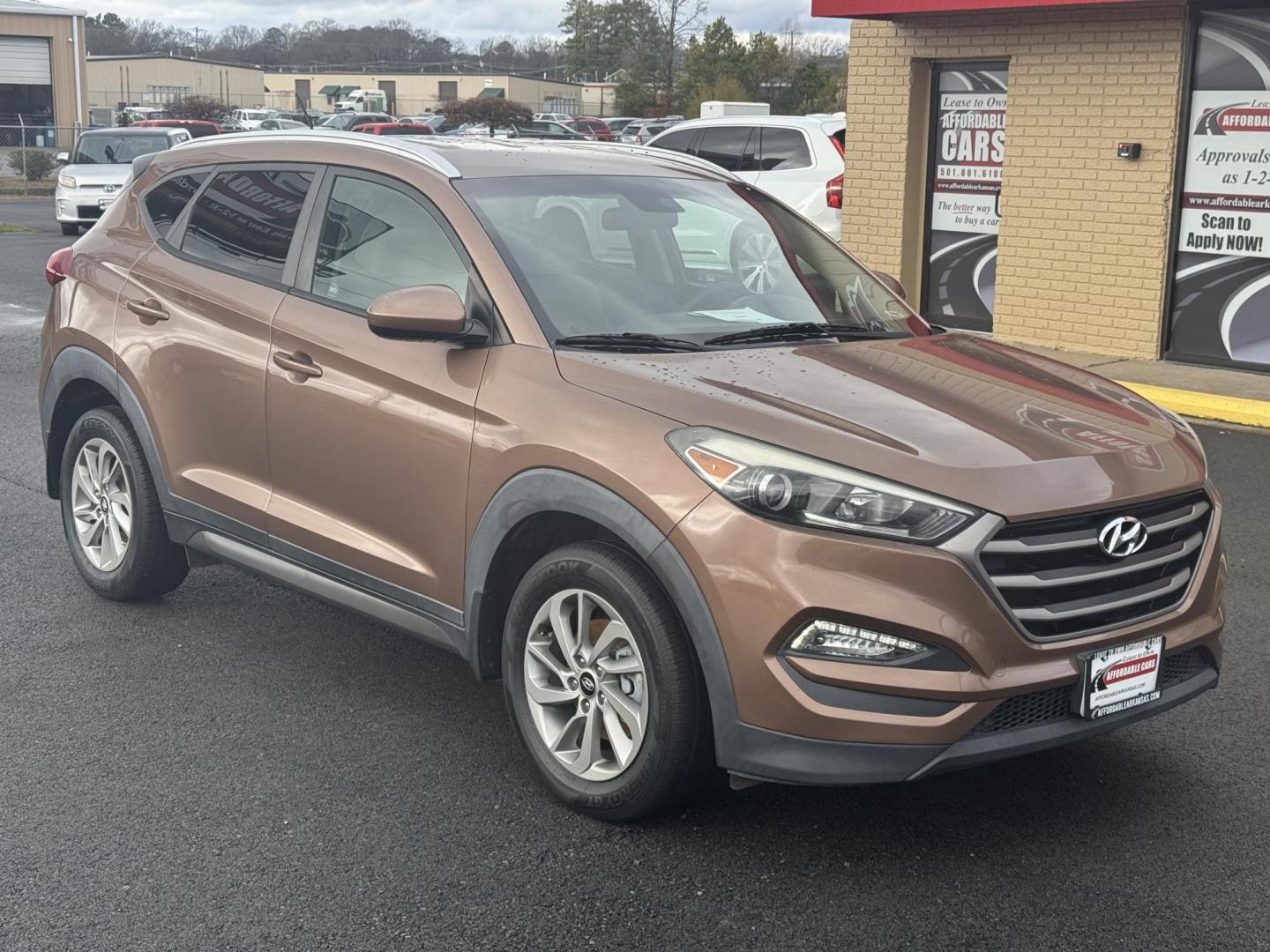 2016 Brown Hyundai Tucson (KM8J33A47GU) with an 4-Cyl, 2.0 Liter engine, Auto, 6-Spd Shiftronic transmission, located at 8008 Warden Rd, Sherwood, AR, 72120, (501) 801-6100, 34.830078, -92.186684 - Photo#1